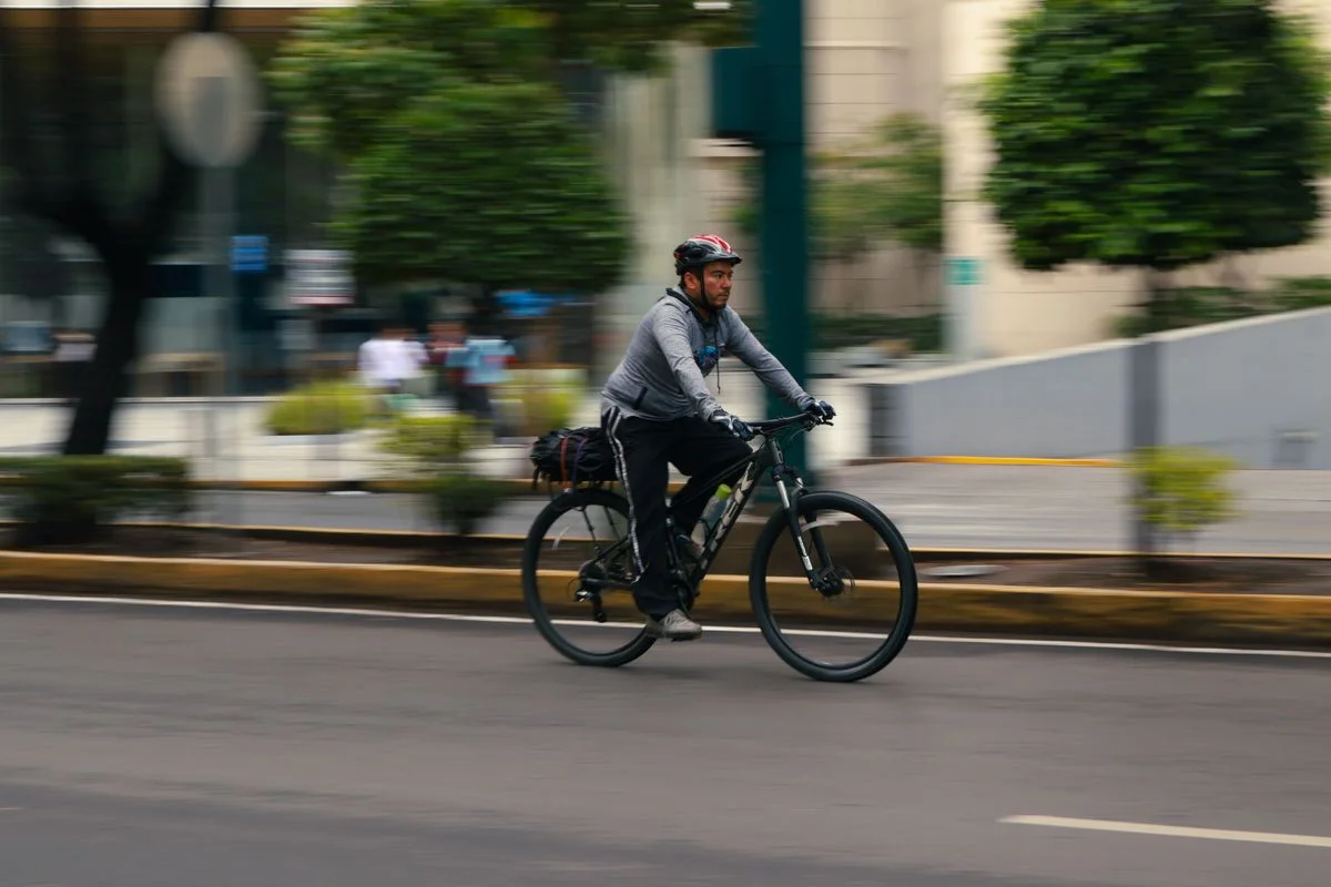 A man cycling rapidly through city streets, showcasing urban biking in motion.